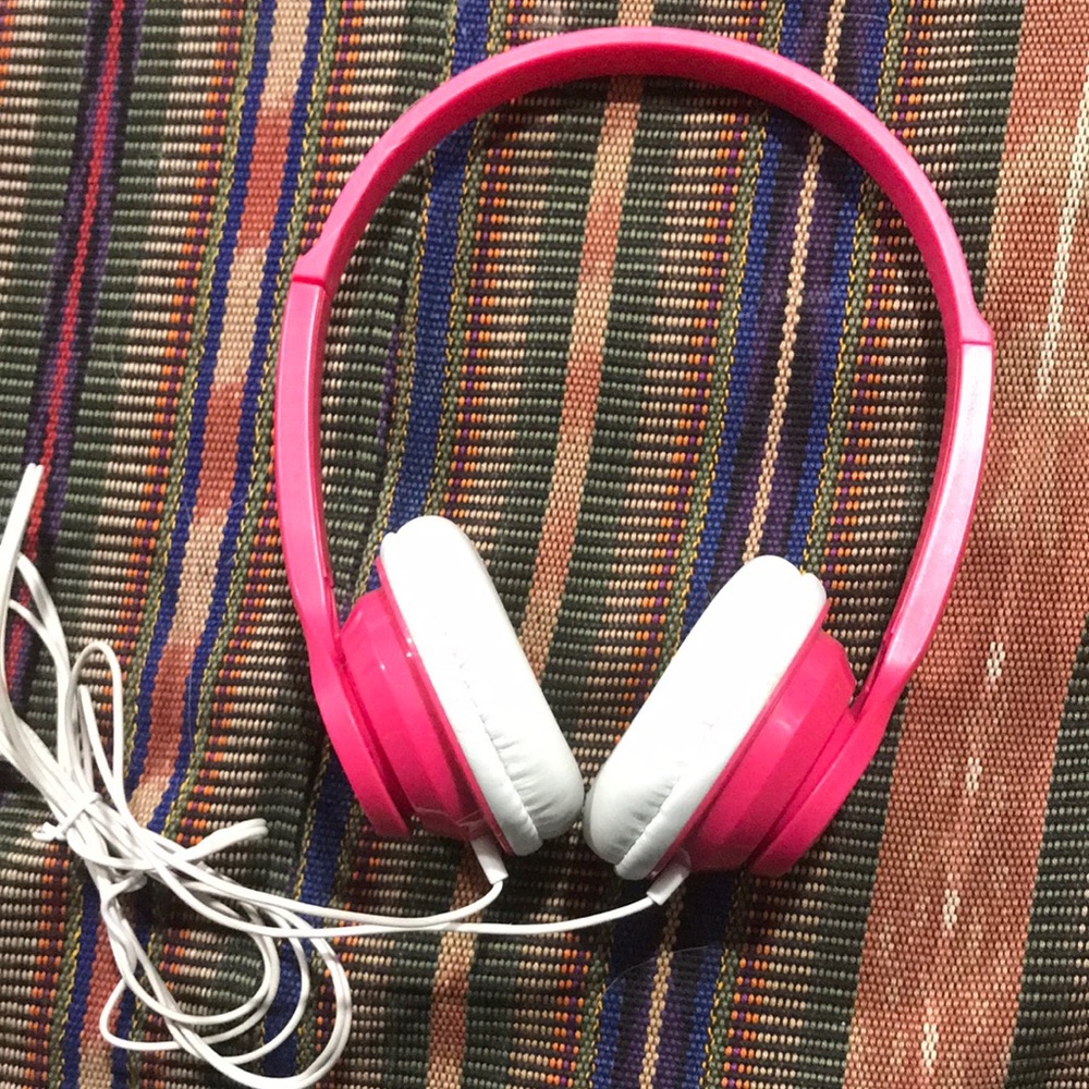 Pink and white earphones with aux cord